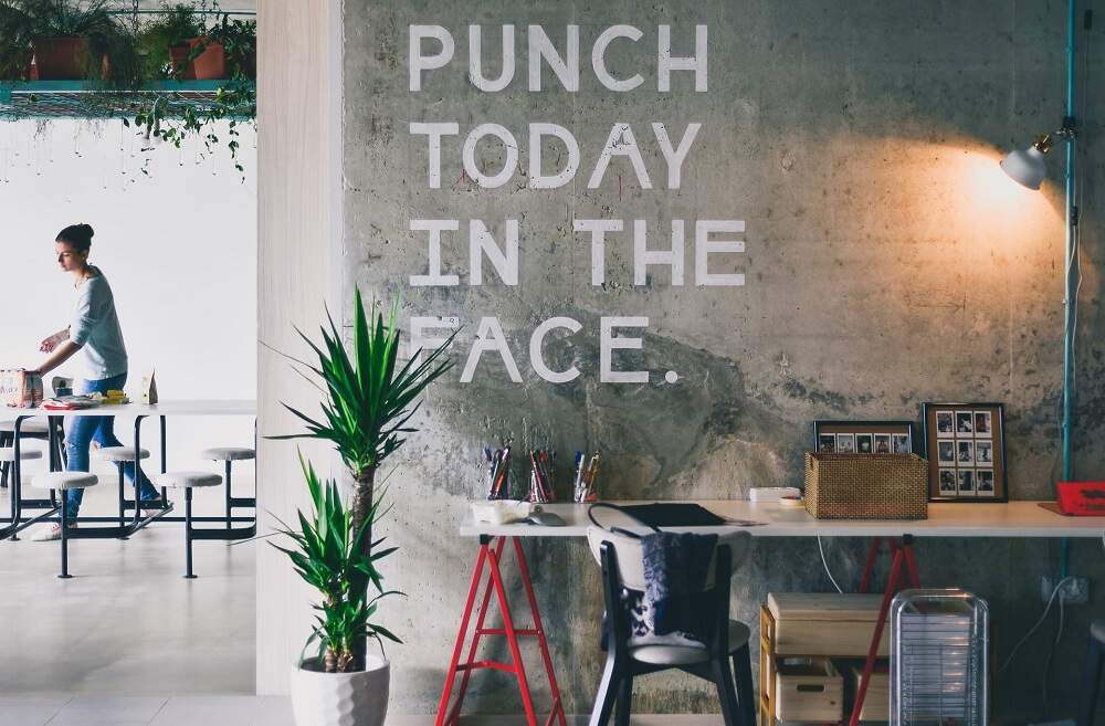 Wall inside the cafe with "Punch today in the face" written on it