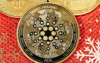 A golden Cardano coin on a top of a red background